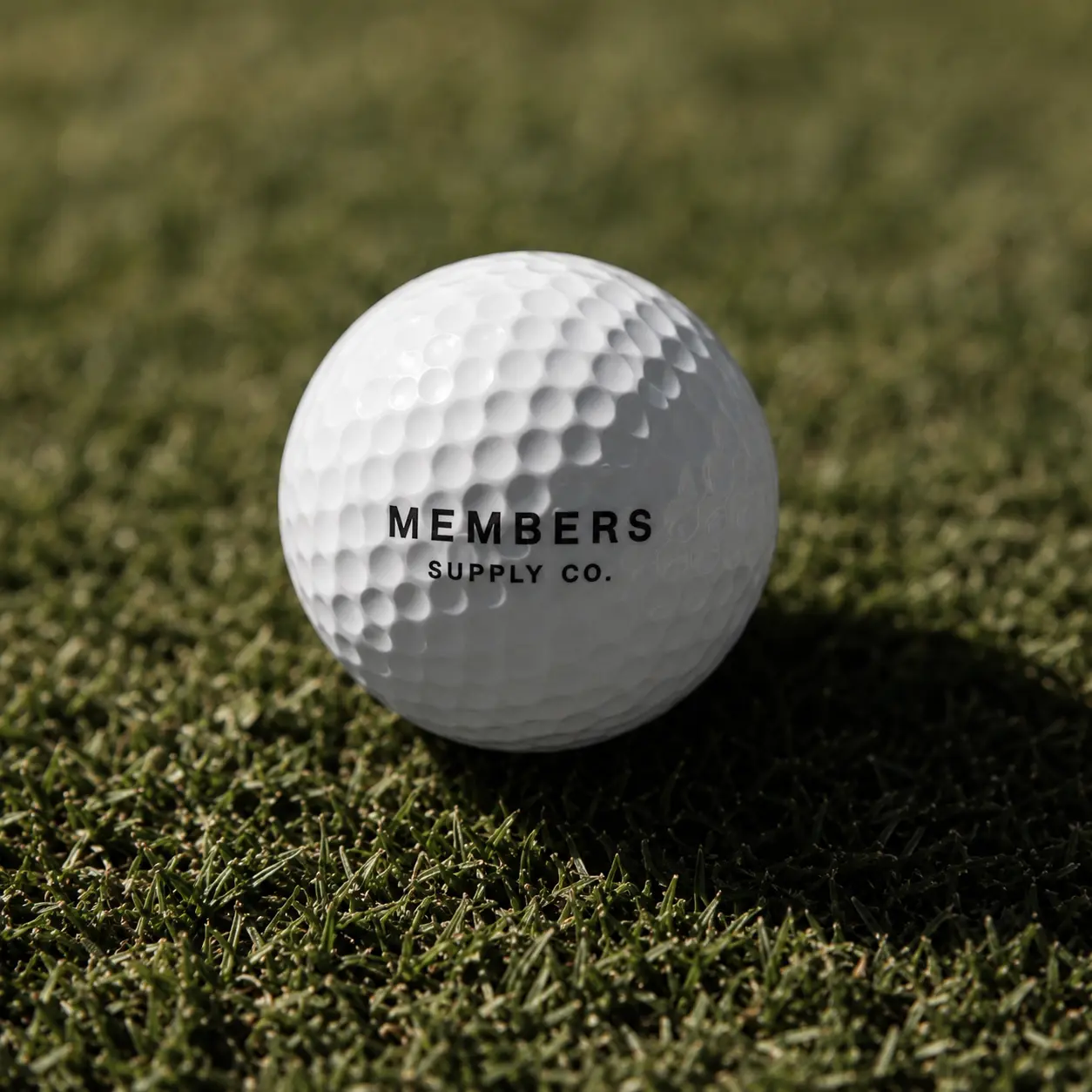 Members Supply Co. golf ball on grass